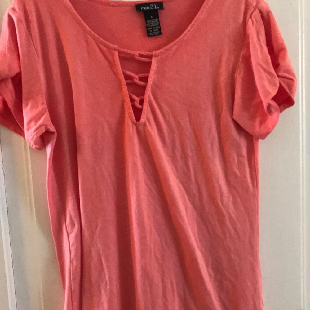 A salmon colored scoop shirt with a tie detail